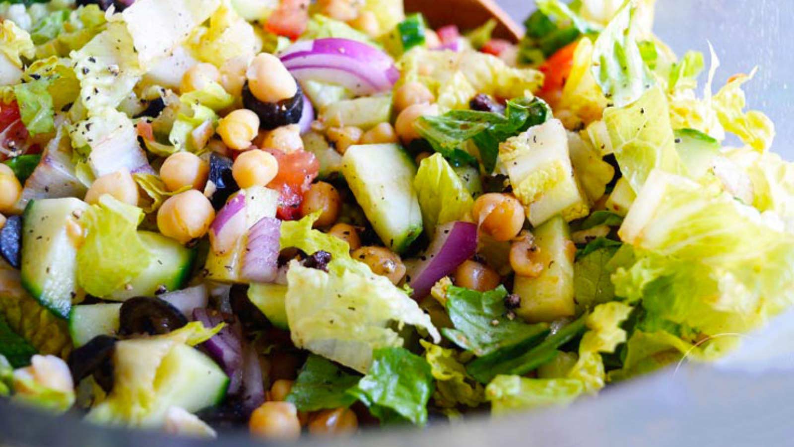 Closeup of an Italian Chopped Salad in a clear bowl.