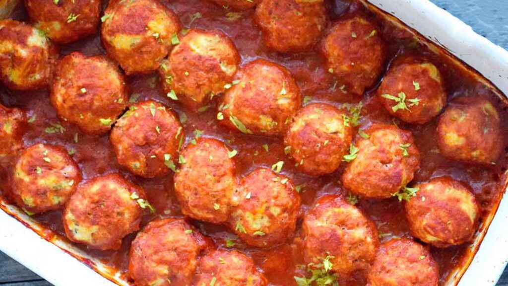 A white casserole dish filled with ground turkey meatballs.