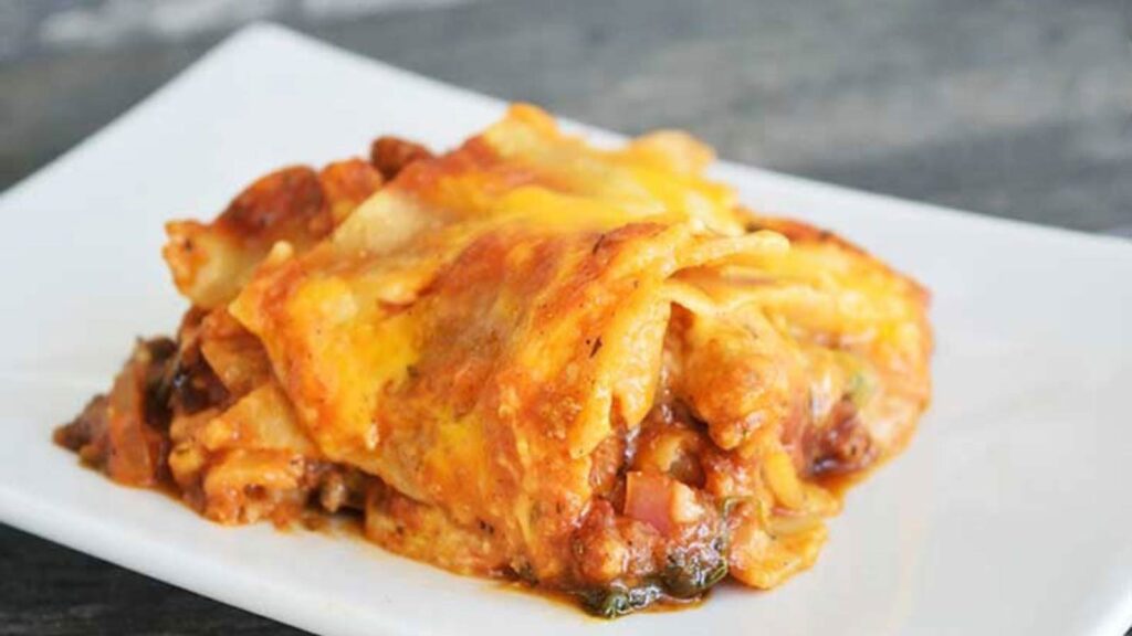 A final slice of this Homemade Lasagna Recipe on a white plate, ready to serve.