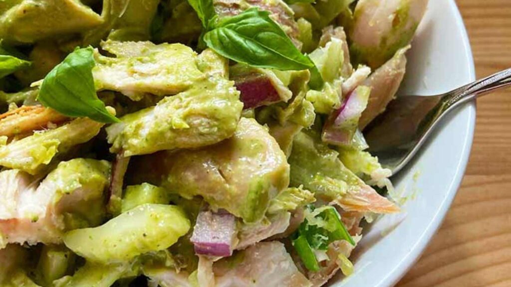 A closeup of a white bowl filled with Lemon Chicken Salad.