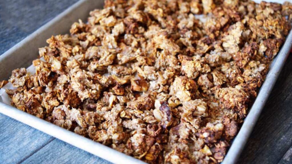 A sheet pan full of Low Sugar Granola clusters.