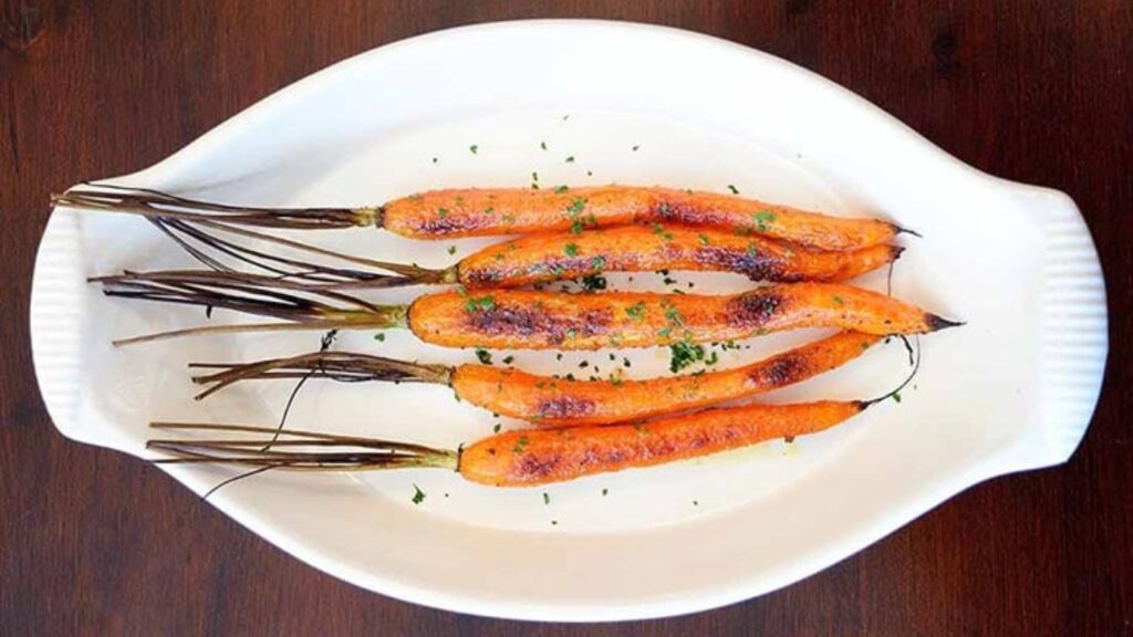 A platter of five individual maple glazed carrots.