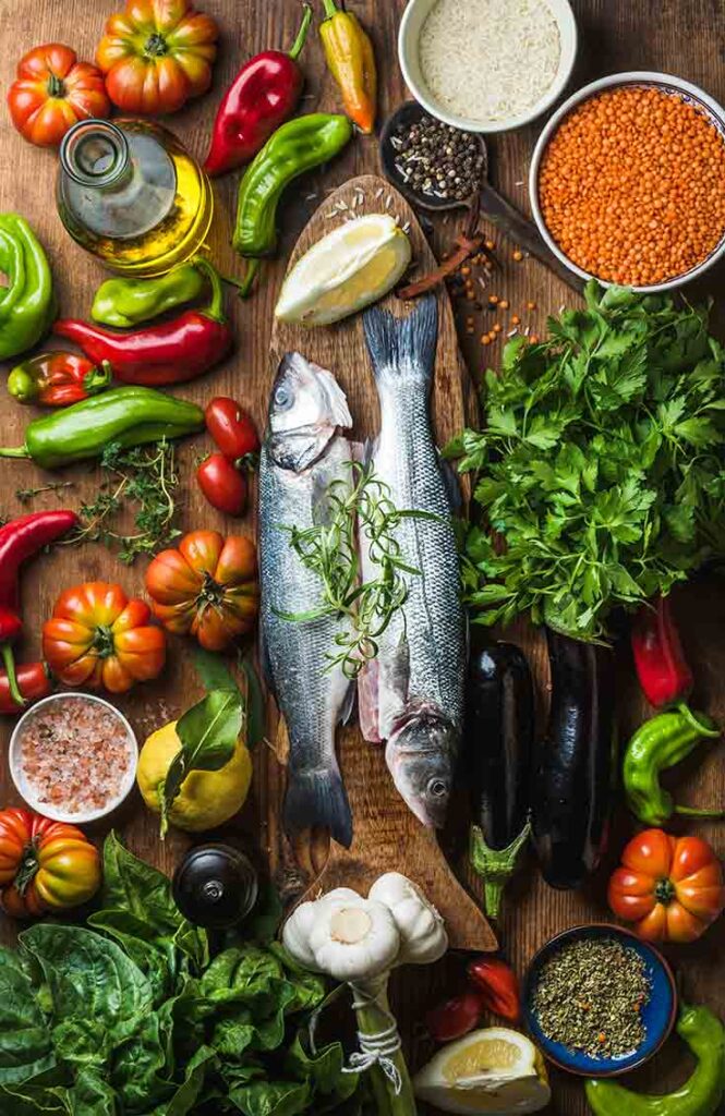 An overhead view of a table filled with Mediterranean ingredients.