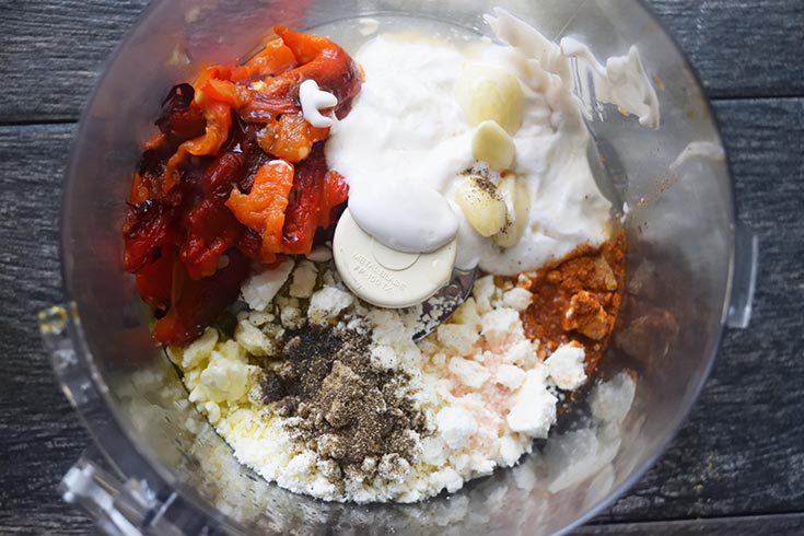 Mediterranean Roasted Red Pepper Dip Recipe ingredients sitting in a food processor bowl.