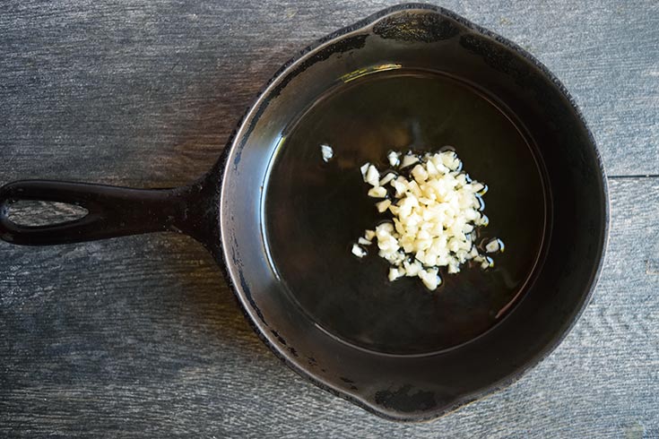 Minced garlic in a cast iron skillet.