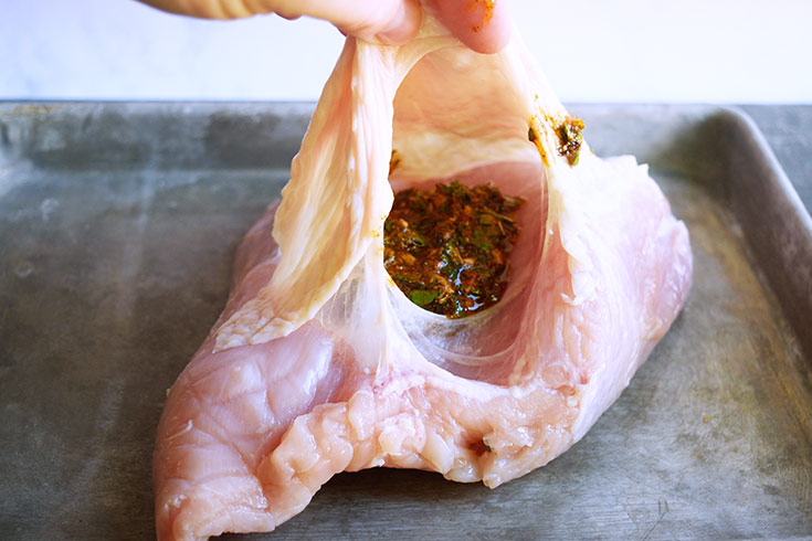 Herb mixture poured under the skin of the turkey breast.
