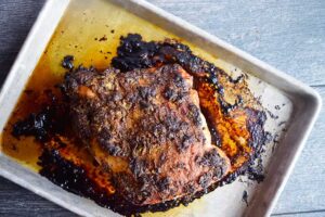 The finished, roasted turkey breast on a sheet pan, cooling.