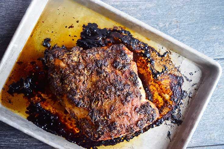 The finished, roasted turkey breast on a sheet pan, cooling.