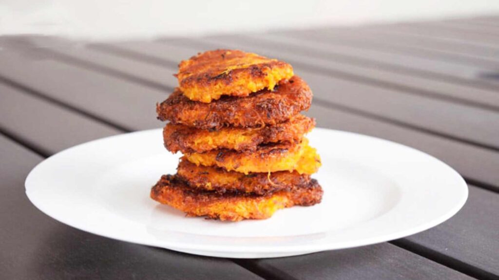 A stack of Sweet Potato Mini Hash Browns on a white plate.