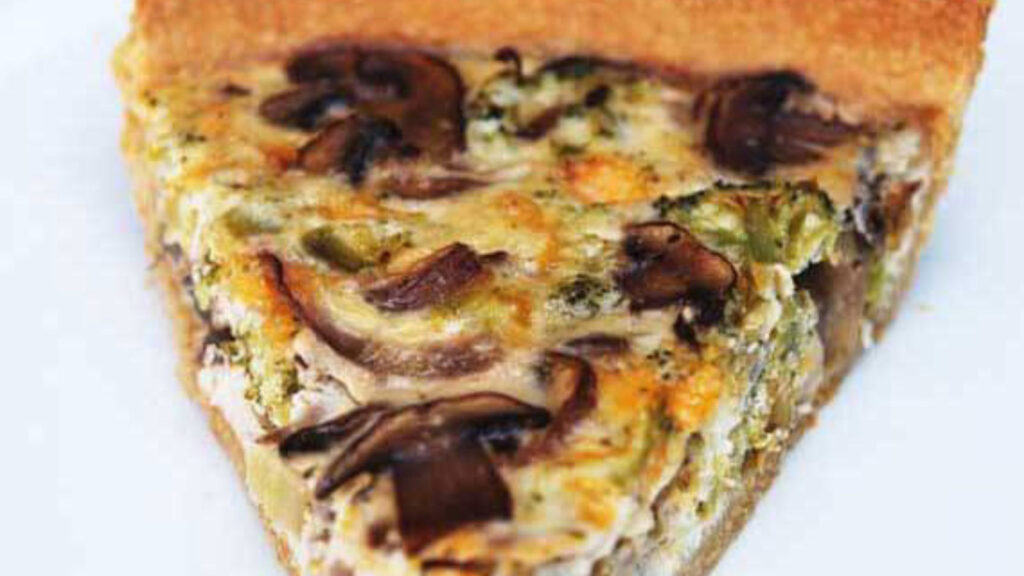 A single slice of Broccoli Mushroom Quich&eacute; on a white plate.