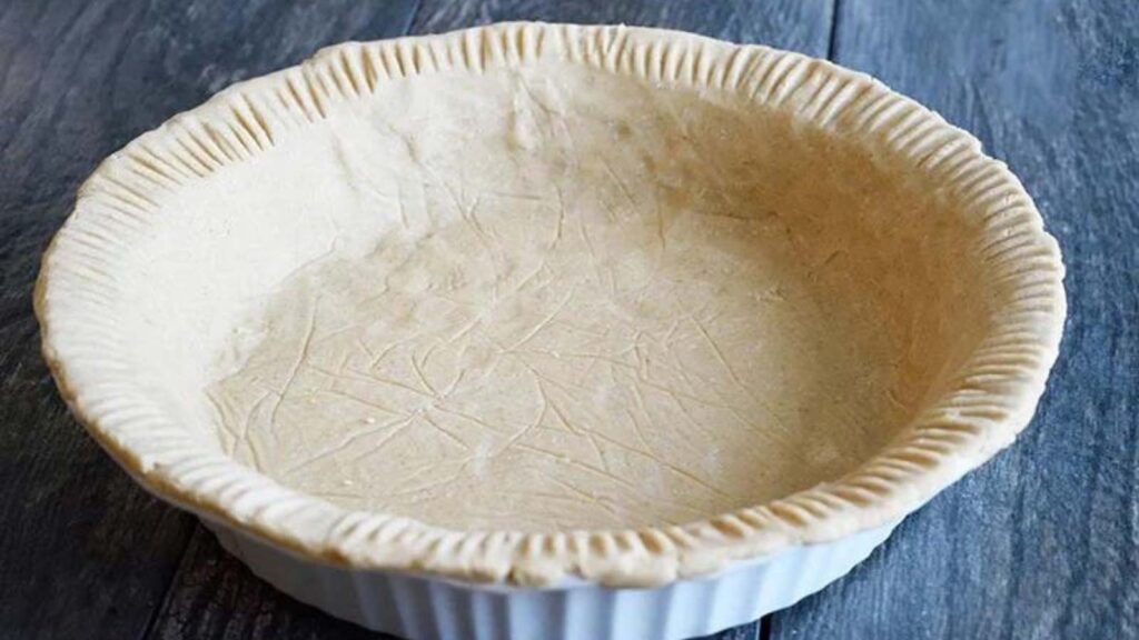 An oat flour pie crust in a pie pan.