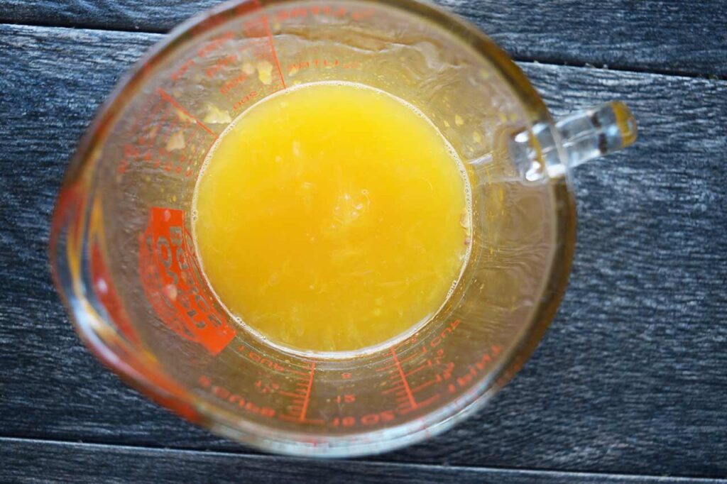 Orange juice in a measuring cup.