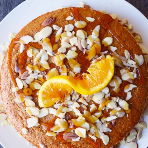 An overhead view of the finished Orange Almond Cake on a white platter.