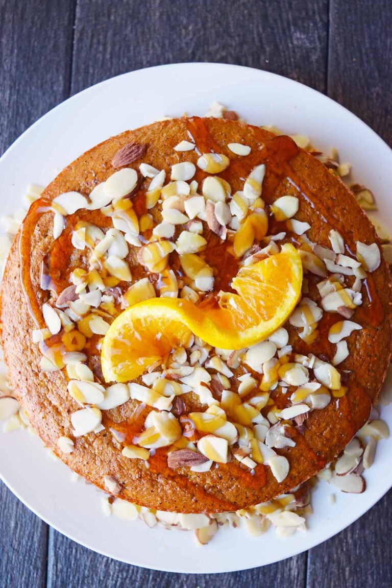 An overhead view of the finished Orange Almond Cake on a white platter.