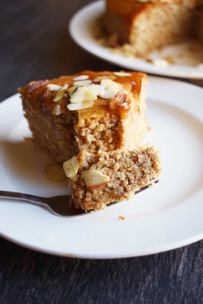 A fork holds a bite of Orange Almond Cake.