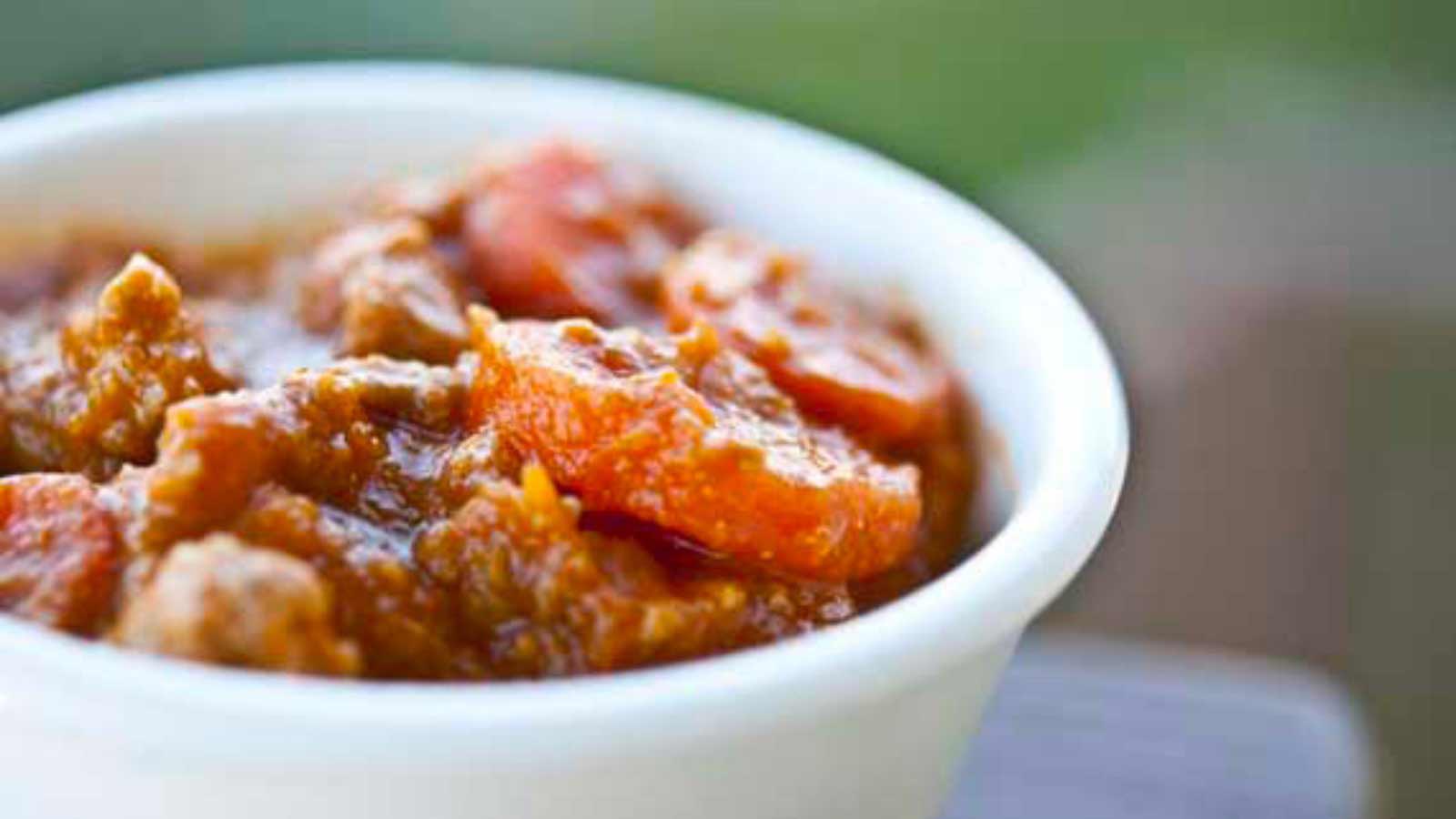 A white bowl filled with pumpkin turkey chili.
