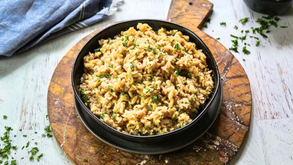 A black bowl full of rice pilaf.