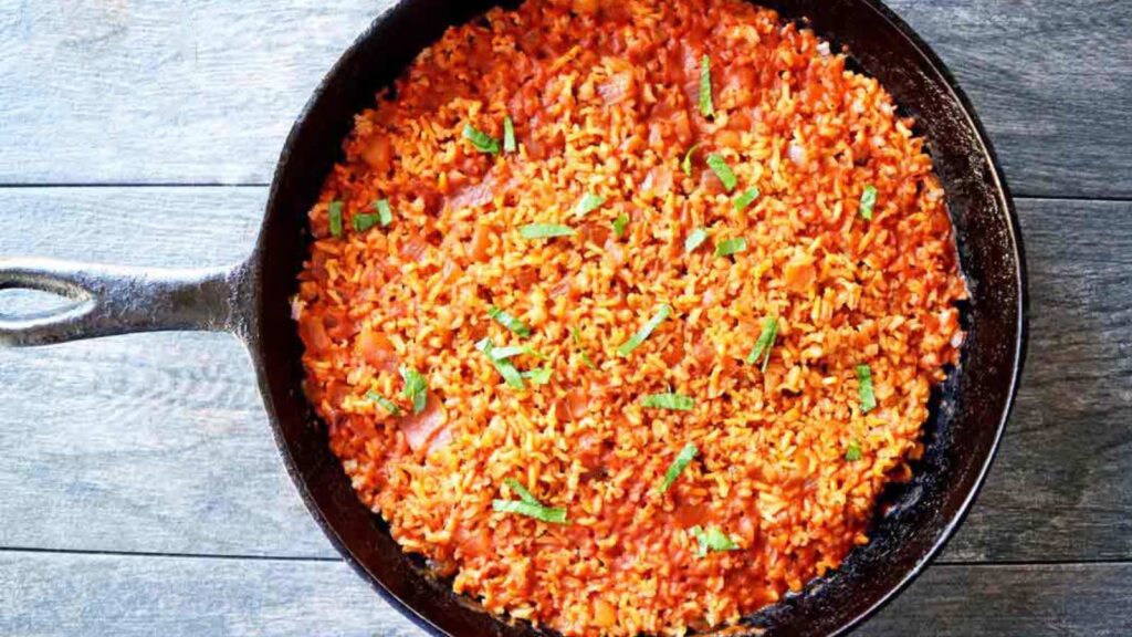 A cast iron skillet full of salsa rice.