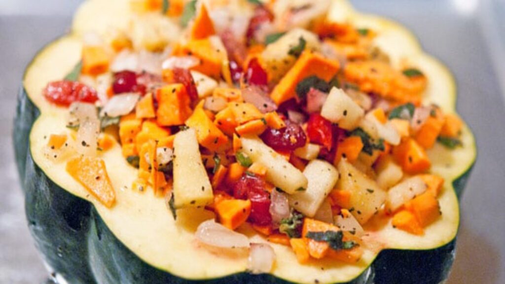 A half of an acorn squash stuffed with vegetables and cranberries.