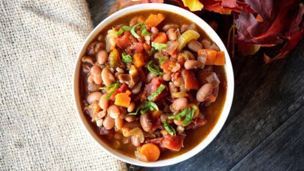 A white bowl filled with Sweet Potato Vegetable Chili.