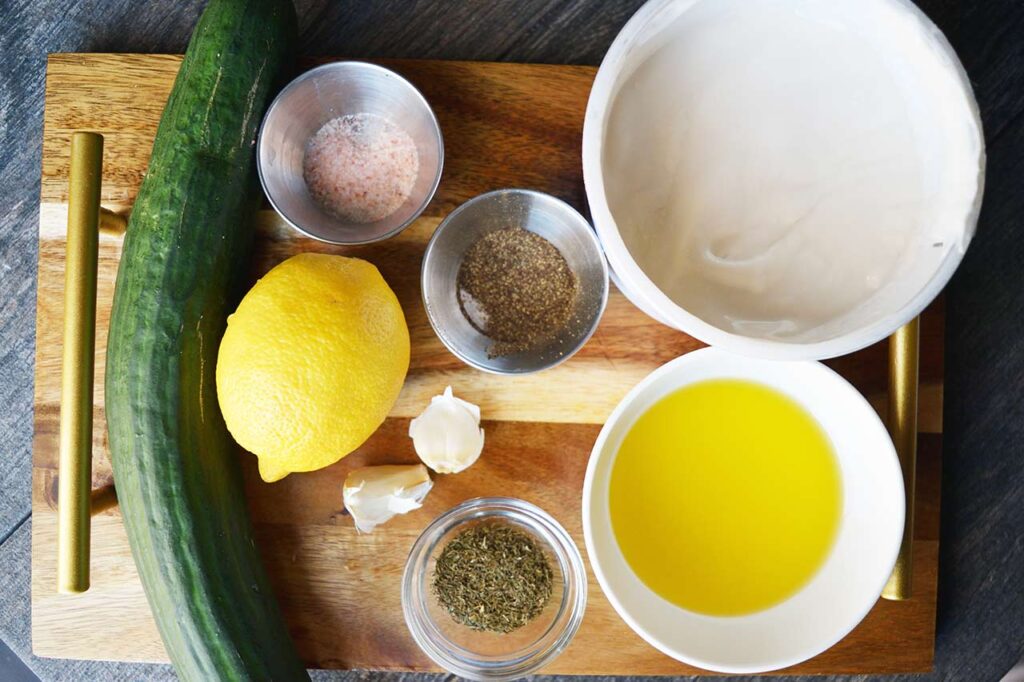 Ingredients for this Tzatziki Recipe sitting on a cutting board.