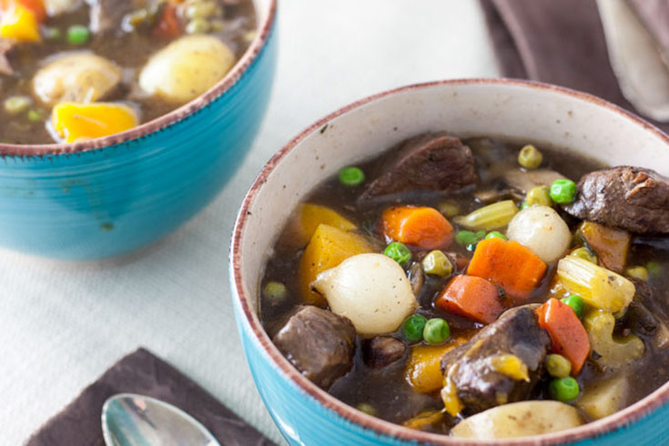 Two bowls of venison stew on a table.