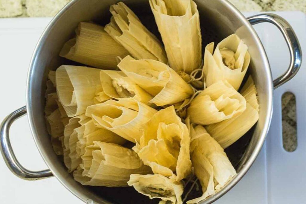 Tamales in a pot sitting on a countertop.