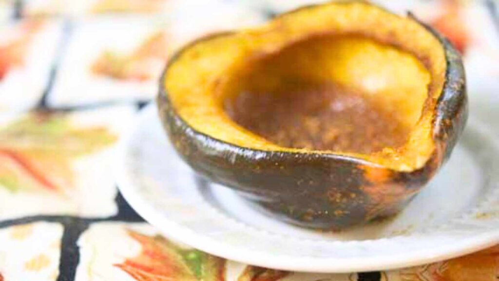 Half of an acorn squash, baked and covered in spices and maple syrup.