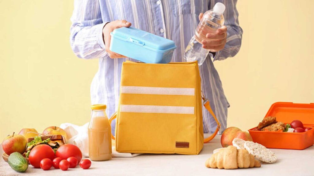 A woman packing a school lunch box.
