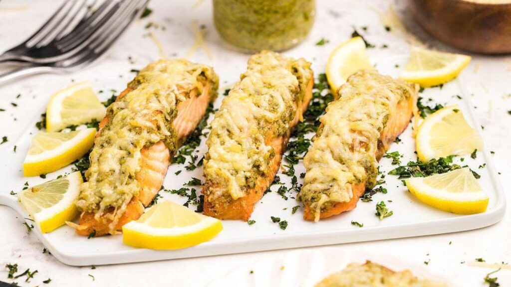 Air fryer pesto salmon filets on a white platter.