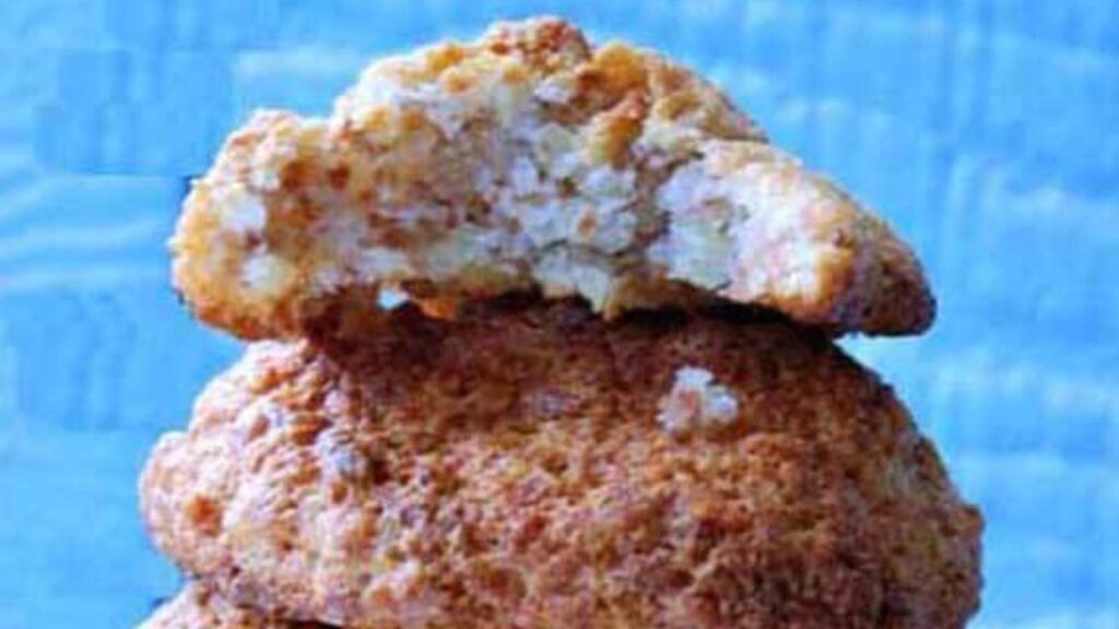 A stack of Almond Honey Cookies against a blue background.