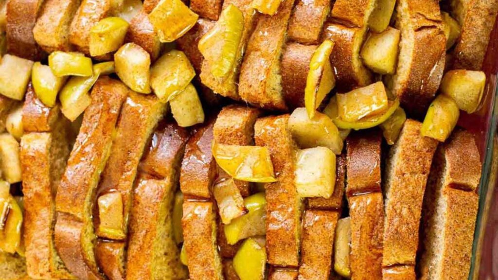 A closeup of apple french toast casserole in a baking dish.