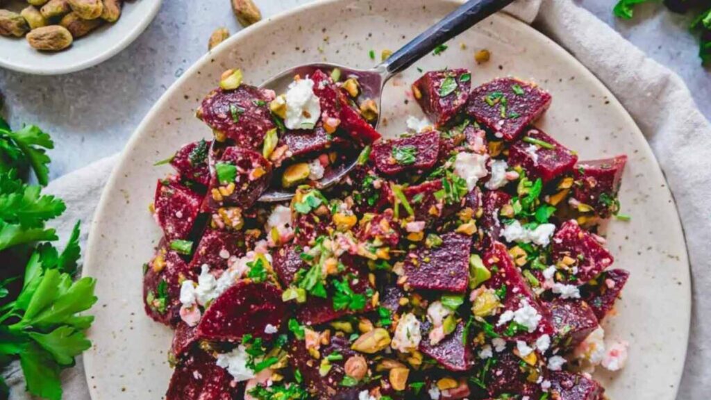 A plate filled with beat salad with feta.