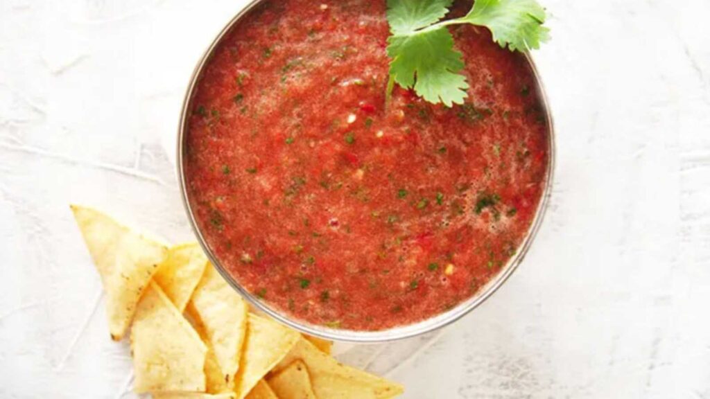 A small metal bowl filled with blender salsa.