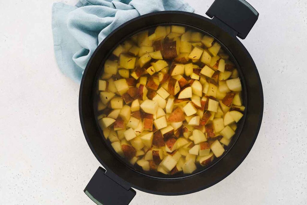 Cut potatoes in a pot.