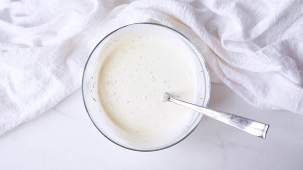 The Buttermilk Ranch Dressing Recipe ingredients mixed together in a small mixing bowl.