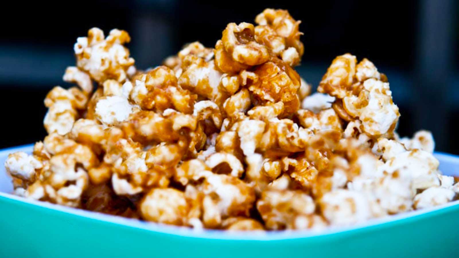 Sticky Caramel Popcorn in an aqua-colored bowl.