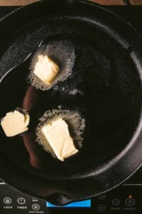Melting butter in a cast iron pot.