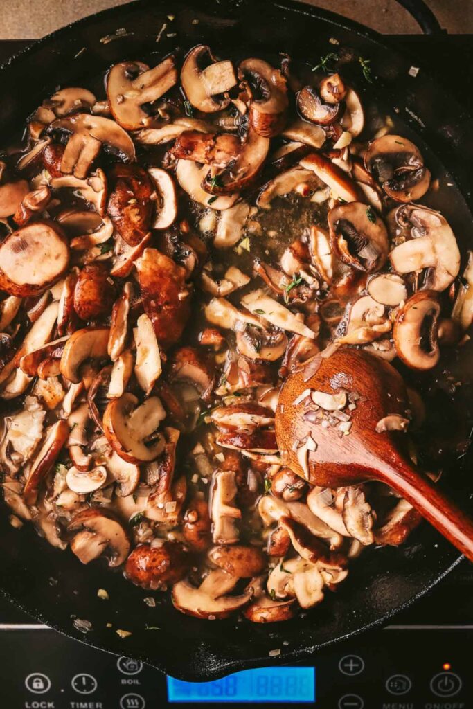 Cooked mushrooms in a cast iron skillet.