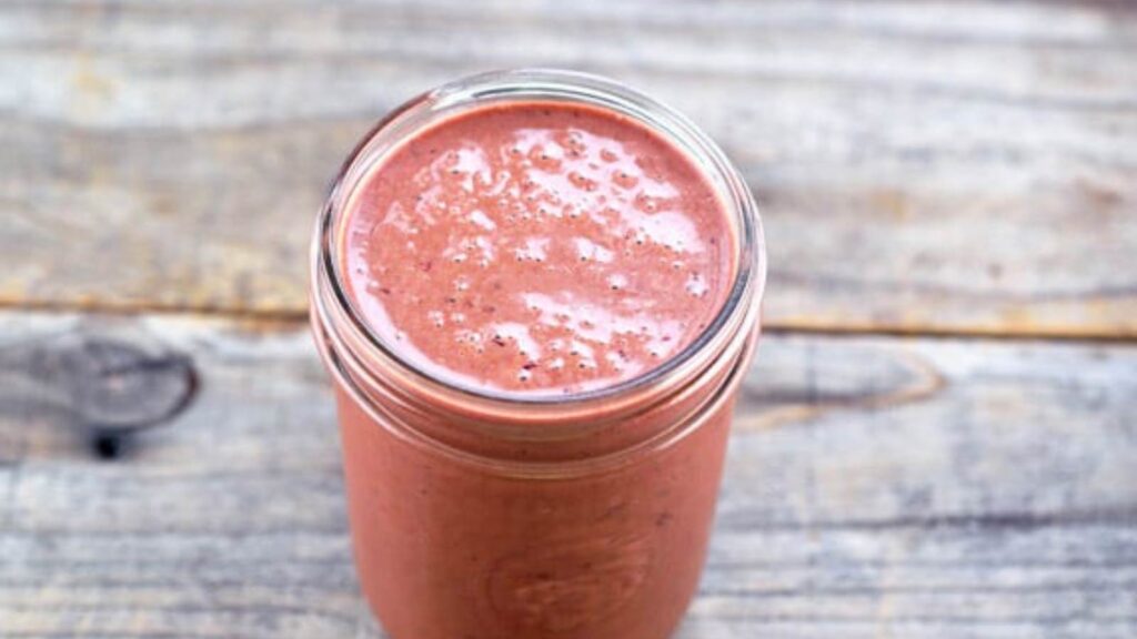 An open canning jar filled with Cherry Vinaigrette.