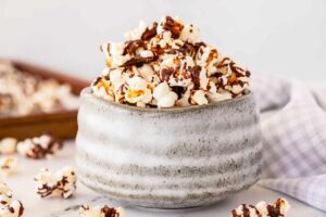 A gray ceramic bowl filled with Chocolate Popcorn.