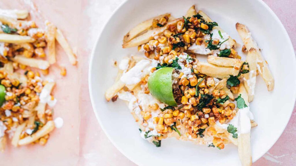 An overhead view of a bowl filled with corn fries.