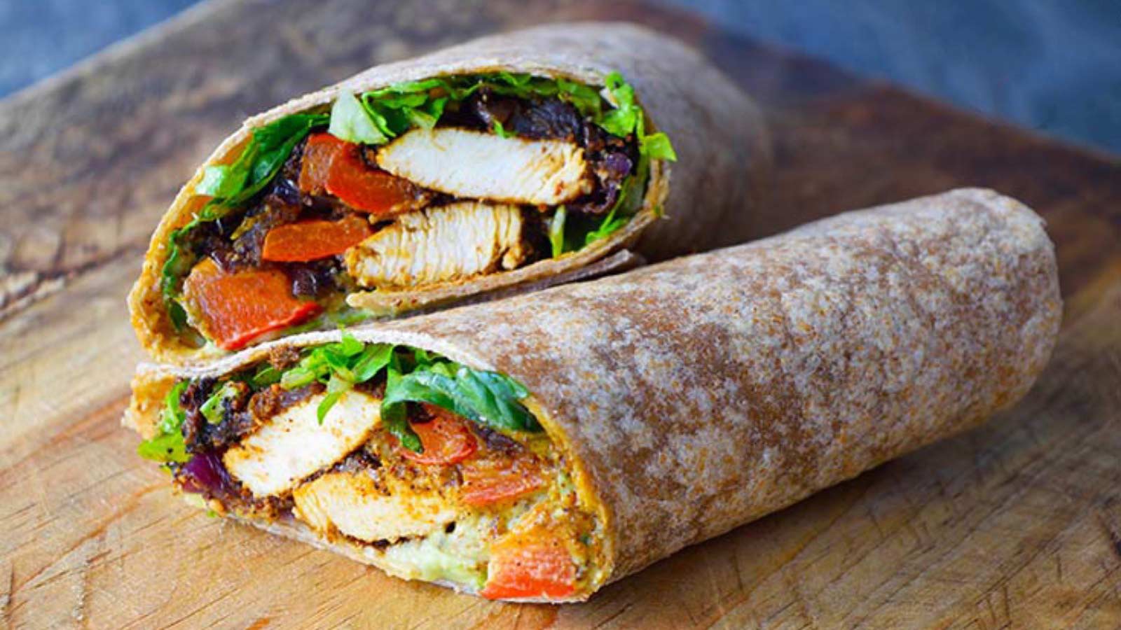 A font view of the cut, finished and stacked Fajita Wrap on a cutting board.