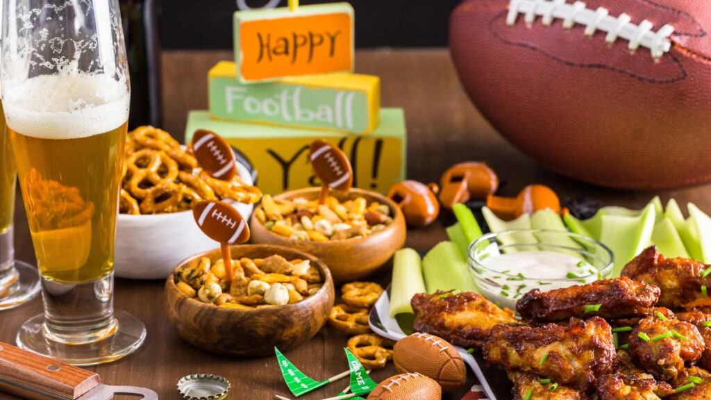 Appetizers on the table for the football party with game-day decor.