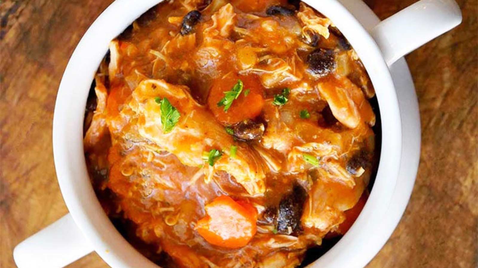 An overhead view of a white crock filled with Instant Pot Chicken Stew.