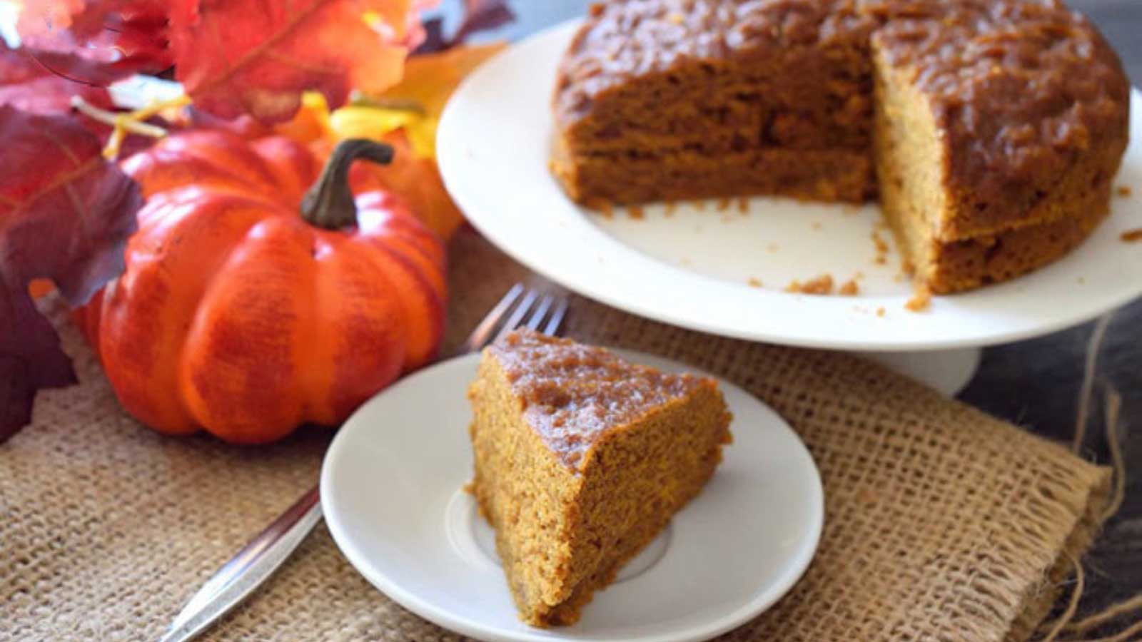 A slice of Pressure Cooker Pumpkin Spice Cake on a white plate.