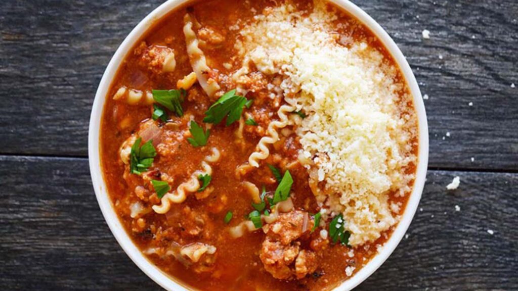 A white bowl filled with Lasagna Soup.