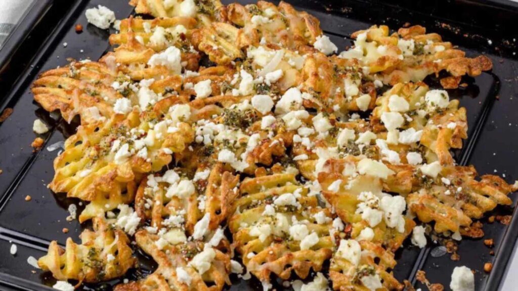 Lemon feta fries on a baking pan.