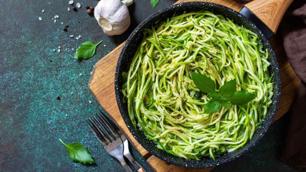 A skillet filled with zucchini noodles.
