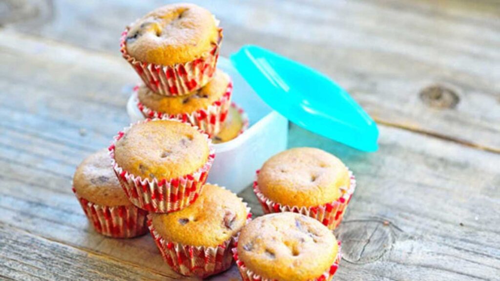 Several Lunchbox Muffins gathered together on a wood surface.